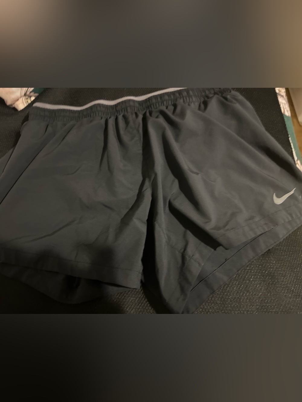 Nike Women's Dark Gray Athletic Shorts  it has little of stain around Nike logo